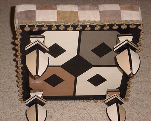 Geometric patterned rug with brown, black, and white shapes.