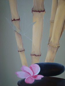 Artificial hand with bamboo-like fingers and a flower decoration.