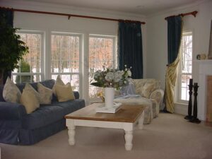 Cozy living room with a dark blue sofa and white coffee table.