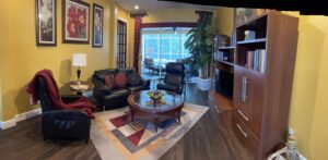 Cozy living room with leather furniture and large window.