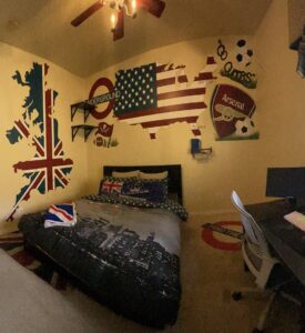 Bedroom with large UK and US flag wall art and themed bedding.