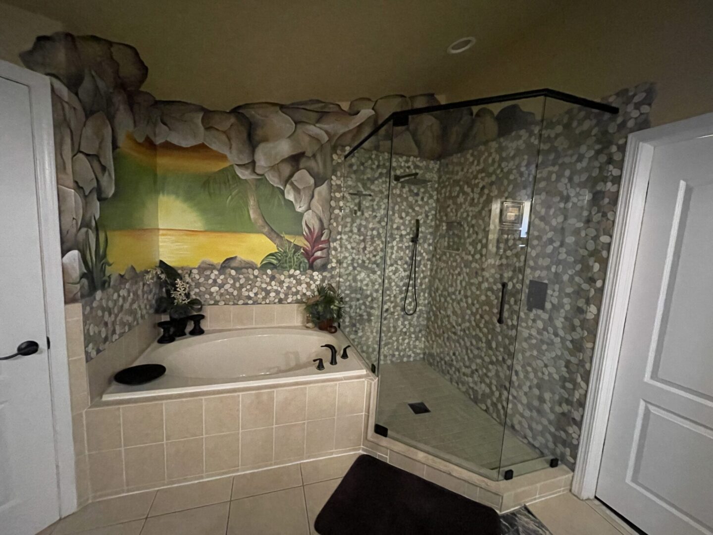 Bathroom with mural and glass shower enclosure.