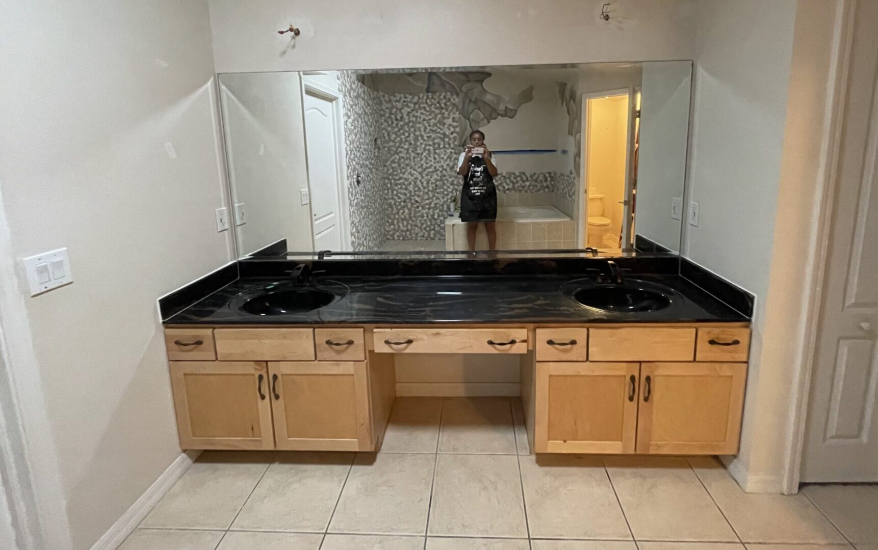 Double sink vanity with large mirror.
