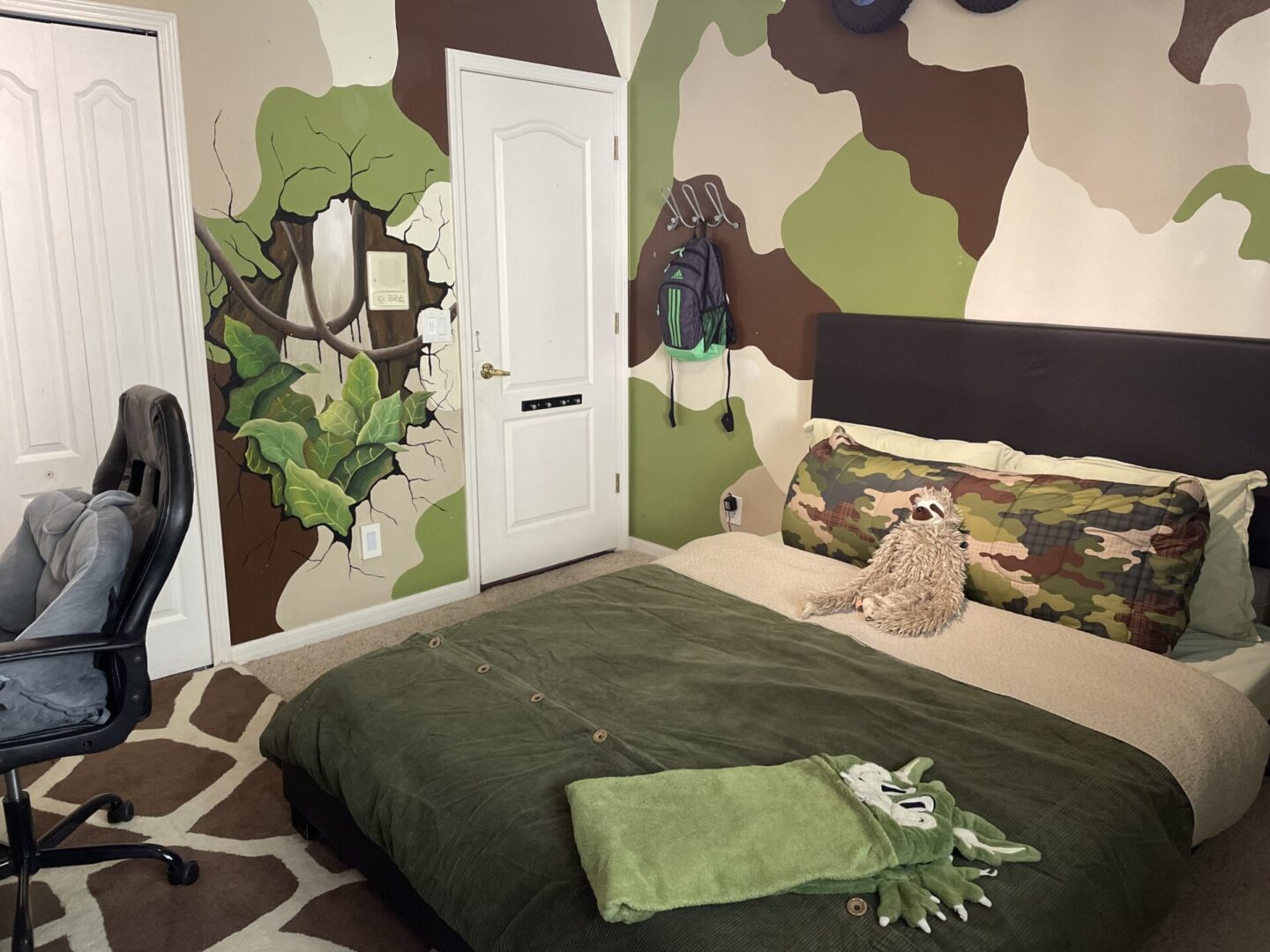 Camouflage-themed bedroom with green and brown decor.