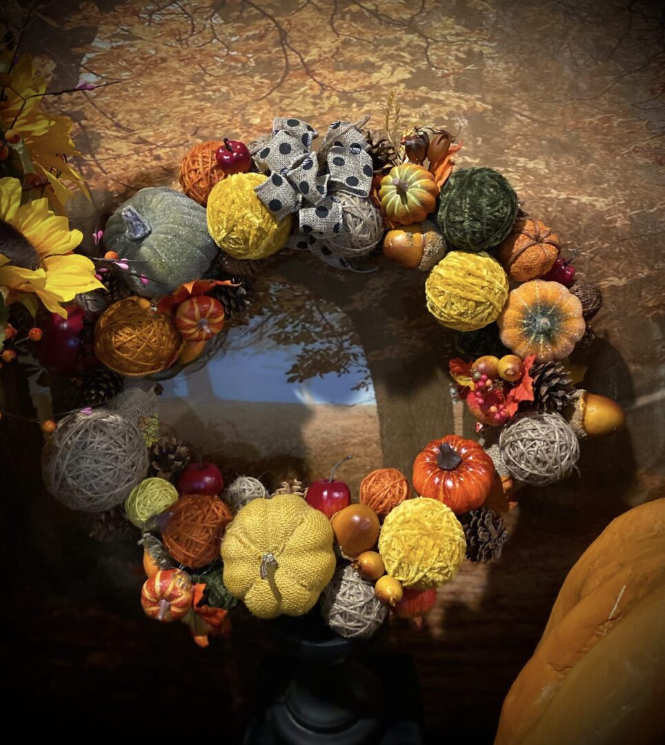 Autumn wreath with pumpkins and decorative elements.