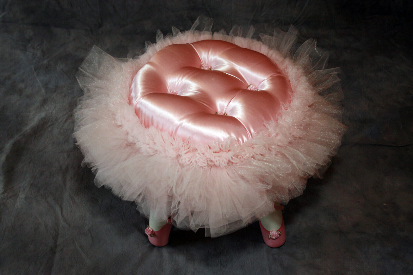 Pink satin stool with fluffy tulle skirt.