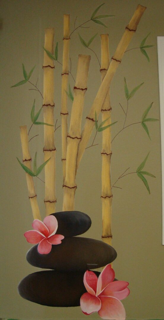 Bamboo, stones, and flowers on green background.